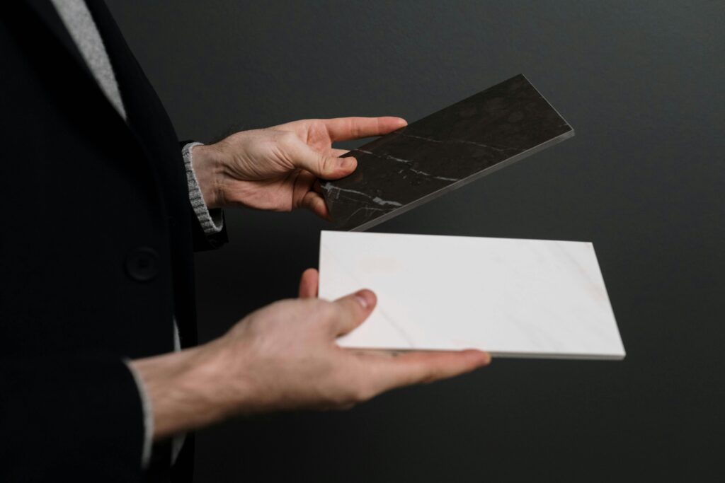 White and Black Marble Tiles in Hands